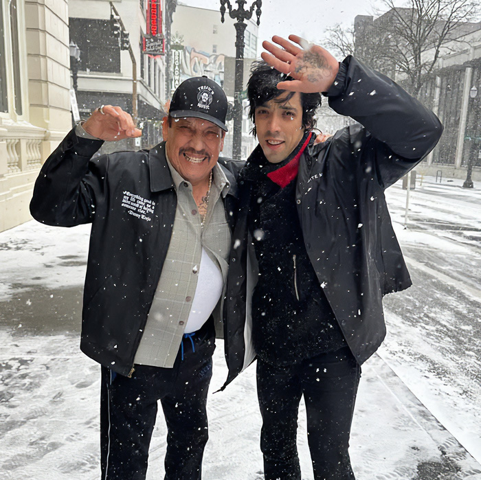 82YO action hero and son smiling together in snowy street 82YO action hero and son smiling together in snowy street