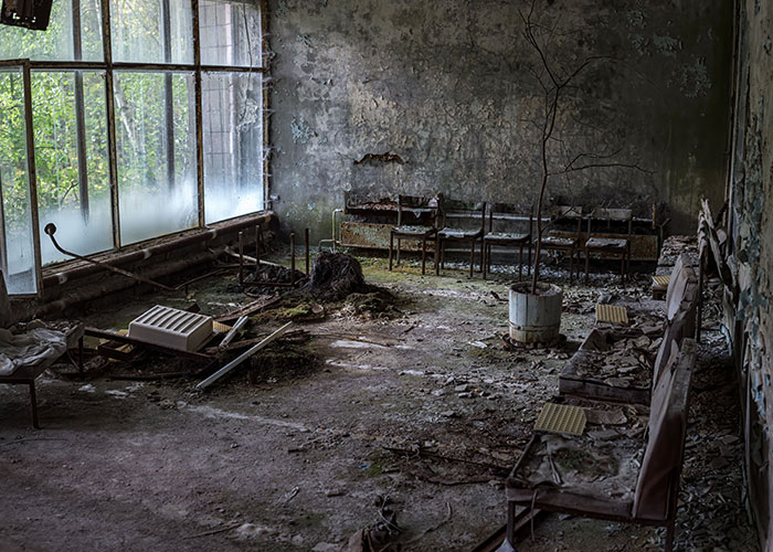 An abandoned room with peeling paint and old chairs tied to online mysteries.