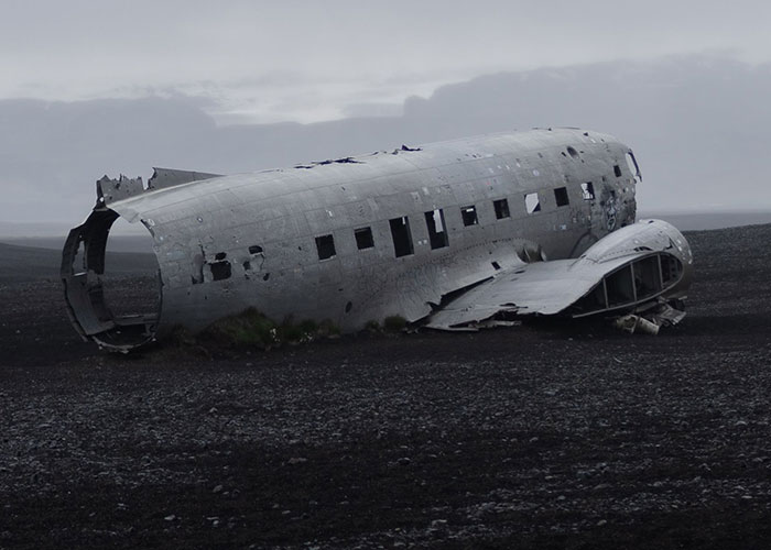 A abandoned plane wreckage on a desolate landscape related to online mysteries.