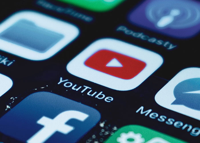 Smartphone screen displaying app icons connected to strange online mysteries like YouTube.