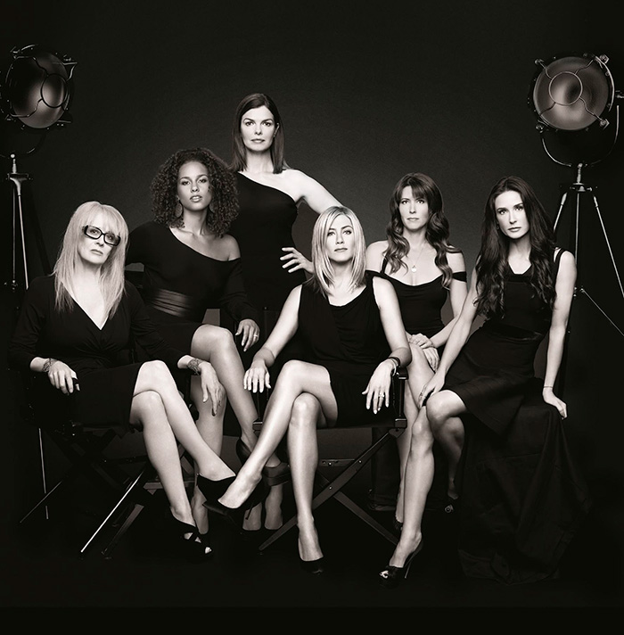 Black and white photo of female cast including Jennifer Aniston in elegant black dresses Black and white photo of female cast including Jennifer Aniston in elegant black dresses