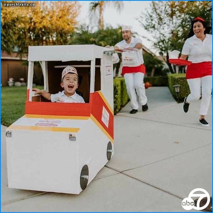 A happy boy in a wheelchair dressed up as an In-N-Out food truck for Halloween