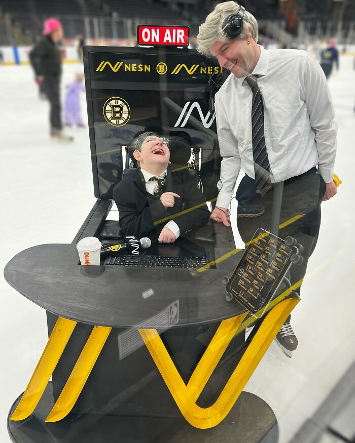 A boy in a wheelchair and an adult dressed as sports announcers for creative Halloween costumes.