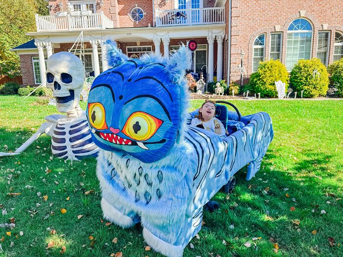 Child in blue tiger wheelchair costume outdoors, an example of creative people with disabilities celebrating Halloween