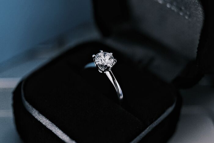 A diamond engagement ring inside a dark velvet box, highlighting famous commercial PR stunts.