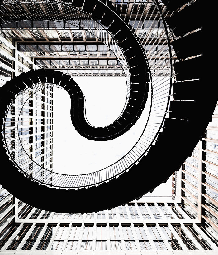 Looking up at a spiraling staircase inside a modern building, representing The Perspa Awards 2026.