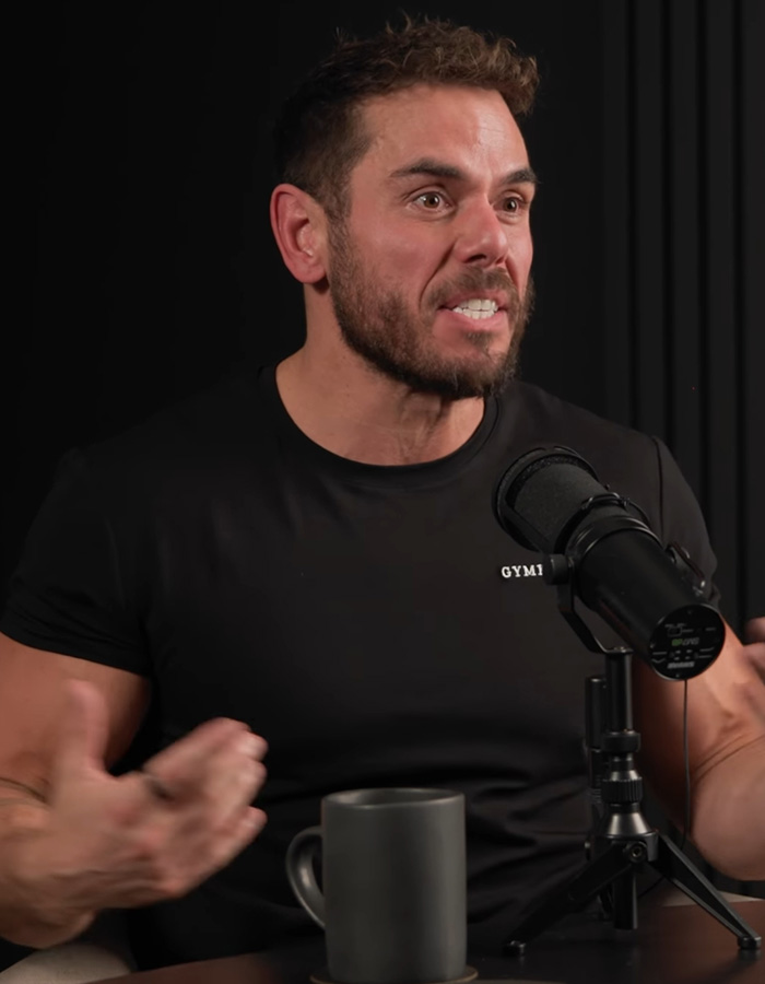 Extreme swimmer speaking passionately into a microphone during a podcast interview. Extreme swimmer speaking passionately into a microphone during a podcast interview.