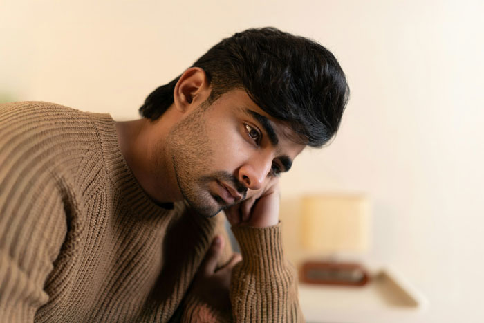 Pensive man reflecting on engagement announcement Pensive man reflecting on engagement announcement