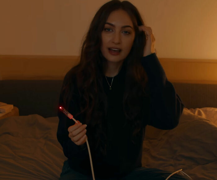 Biohacker Bryan Johnson girlfriend holding a glowing red health sensor device Biohacker Bryan Johnson girlfriend holding a glowing red health sensor device