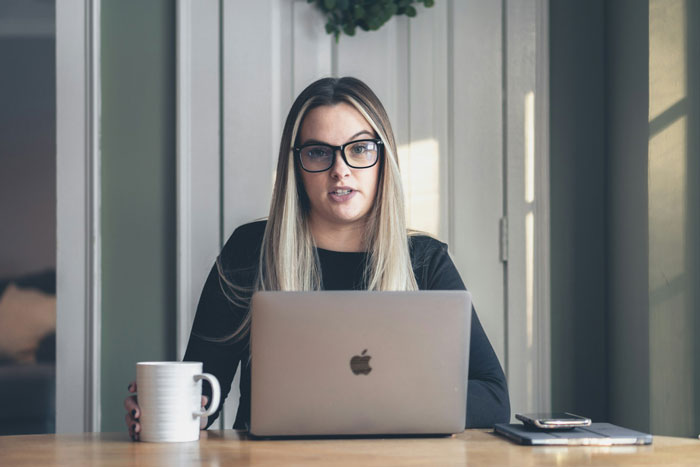 A woman sits with her laptop, contemplating petty revenge against her ex-fiance.
