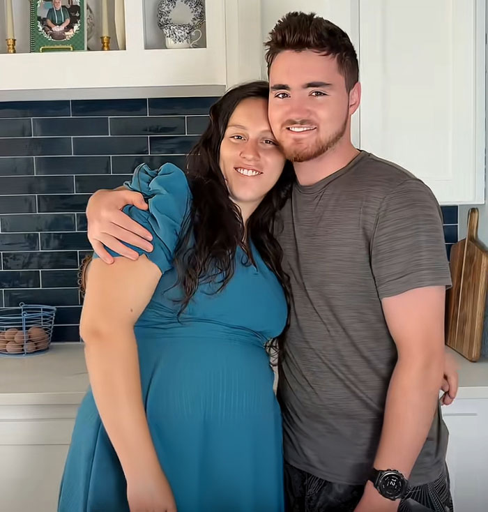 Lovina Zook with a man smiling and hugging in a kitchen, highlighting Amish online influencer presence Lovina Zook with a man smiling and hugging in a kitchen, highlighting Amish online influencer presence