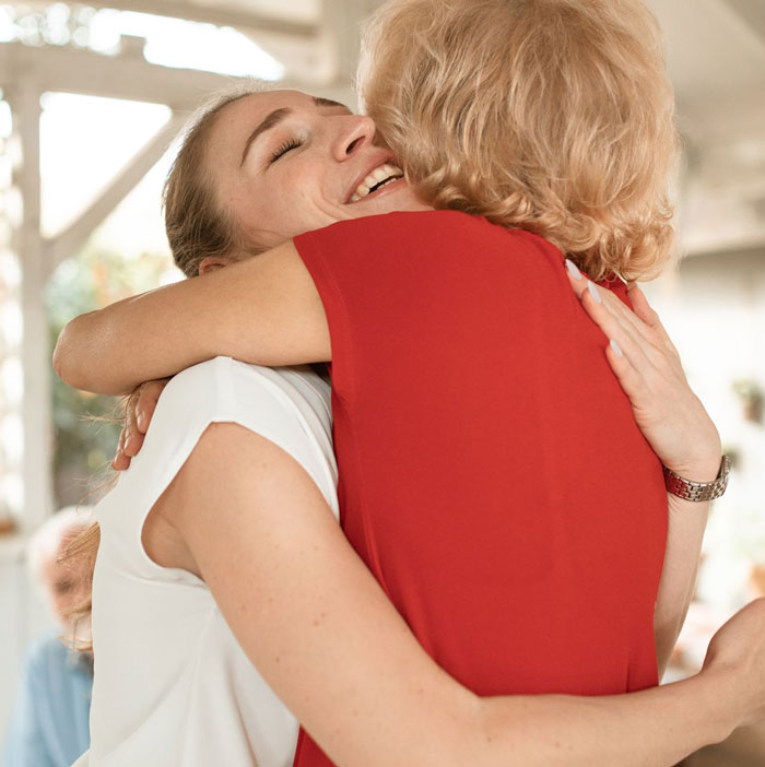 Two happy women hugging close together, referencing a woman who takes petty revenge against ex-fianc&eacute;