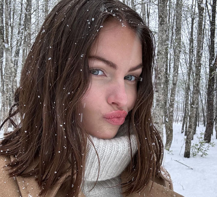 French model Thylane Blondeau posing in a snowy forest with a winter coat and white turtleneck sweater. French model Thylane Blondeau posing in a snowy forest with a winter coat and white turtleneck sweater.