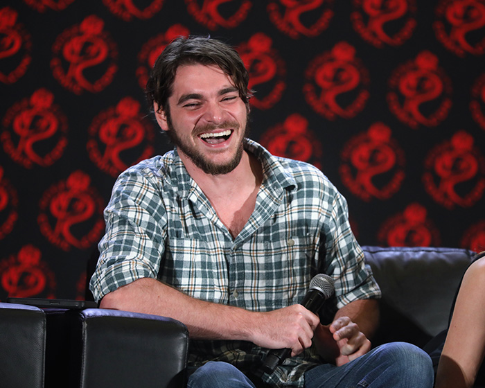 RJ Mitte laughing into a microphone during an interview panel. RJ Mitte laughing into a microphone during an interview panel.