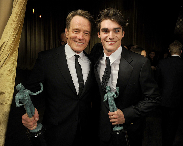 RJ Mitte and Bryan Cranston posing with SAG Awards in suits. RJ Mitte and Bryan Cranston posing with SAG Awards in suits.