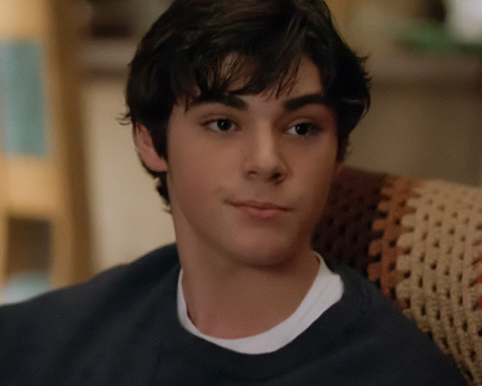 A young RJ Mitte as Walter White Jr in Breaking Bad, looking thoughtful. A young RJ Mitte as Walter White Jr in Breaking Bad, looking thoughtful.