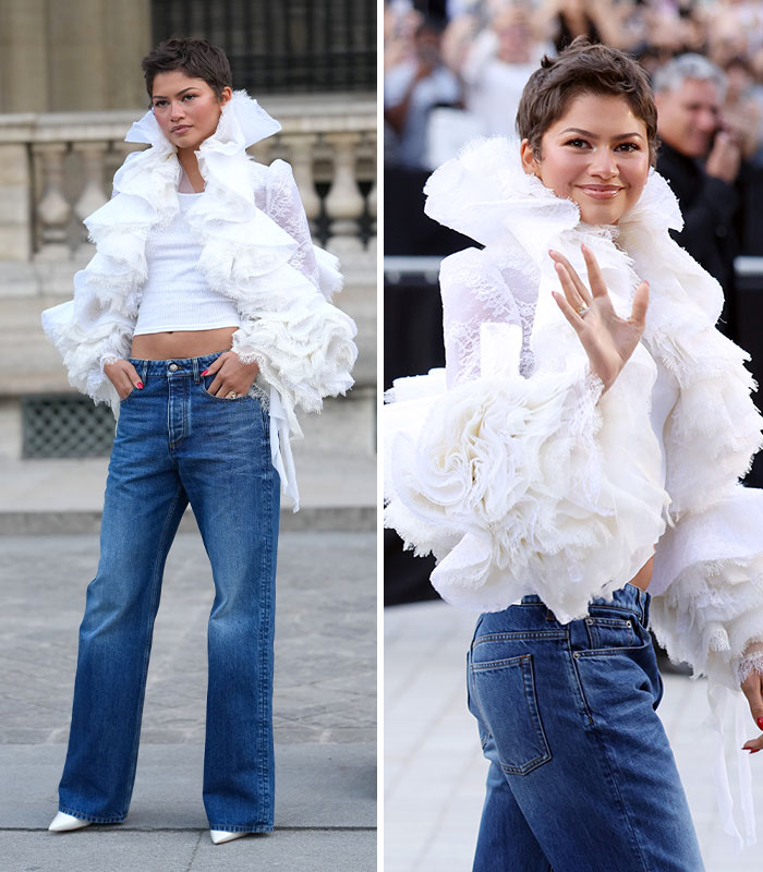 Zendaya wearing a dramatic ruffled white jacket with jeans at the 2026 Paris Fashion Week.