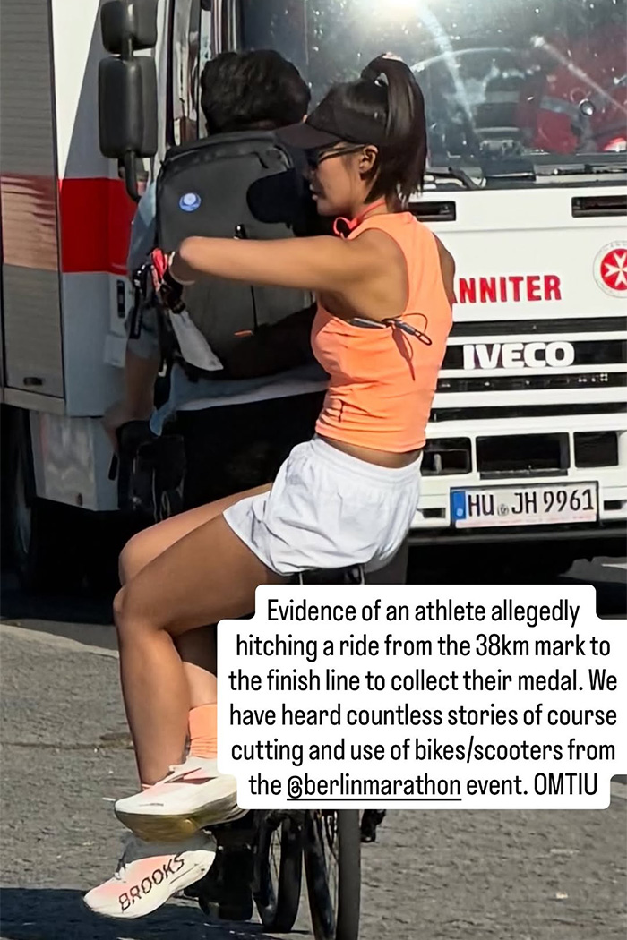 Fitness influencer riding on the back of a bike to skip sections of the marathon Fitness influencer riding on the back of a bike to skip sections of the marathon
