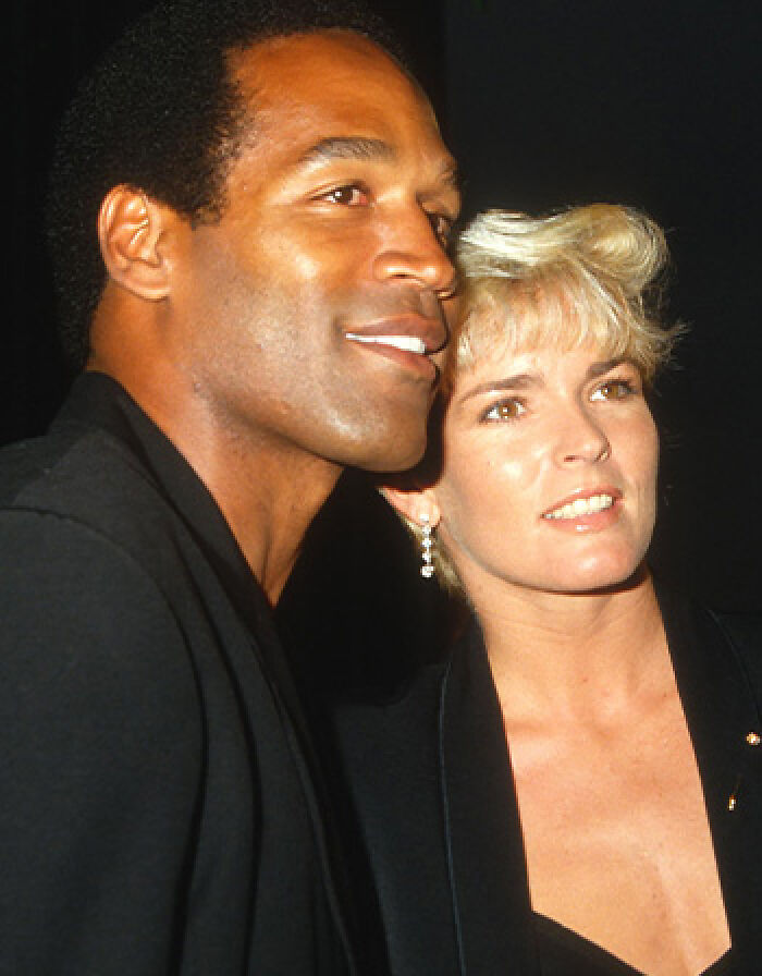 O.J. Simpson and Nicole Brown Simpson posing together closely at a public event. O.J. Simpson and Nicole Brown Simpson posing together closely at a public event.