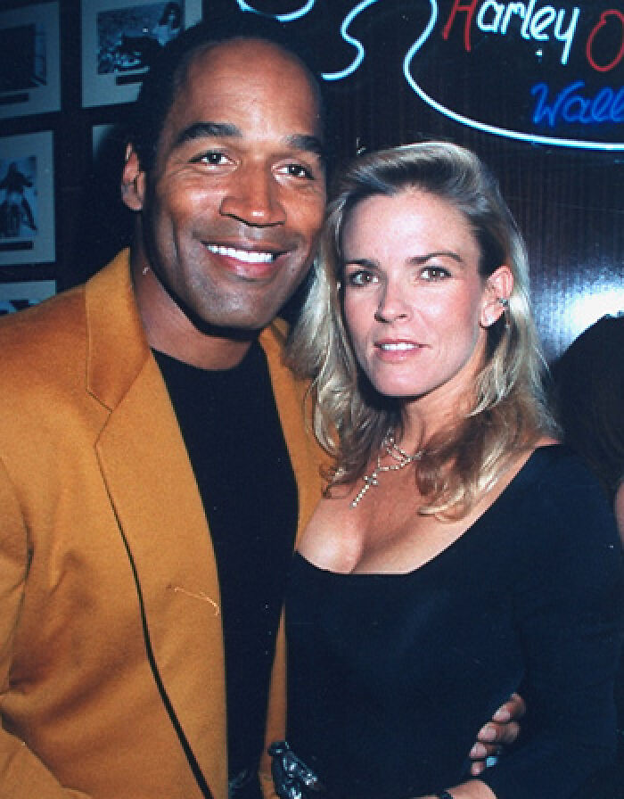 O.J. Simpson and Nicole Brown Simpson smiling together at an event, key figures in the O.J. Simpson case O.J. Simpson and Nicole Brown Simpson smiling together at an event, key figures in the O.J. Simpson case