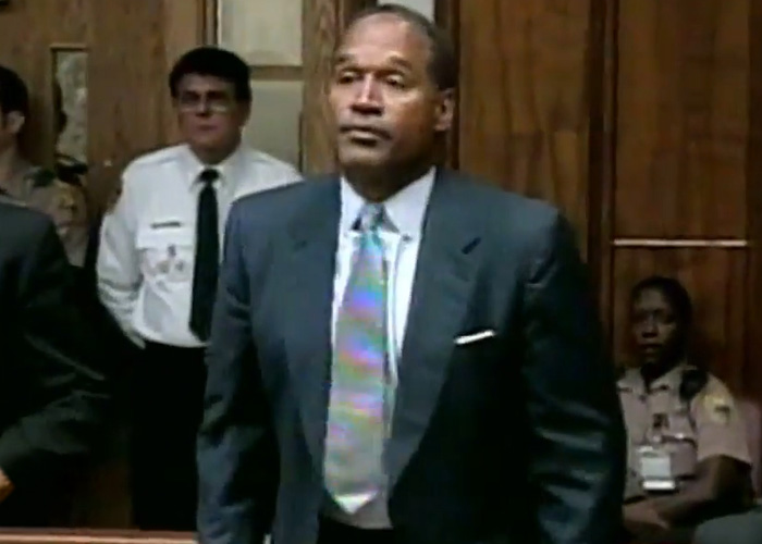 O.J. Simpson wearing a grey suit and colorful tie during his high-profile trial. O.J. Simpson wearing a grey suit and colorful tie during his high-profile trial.