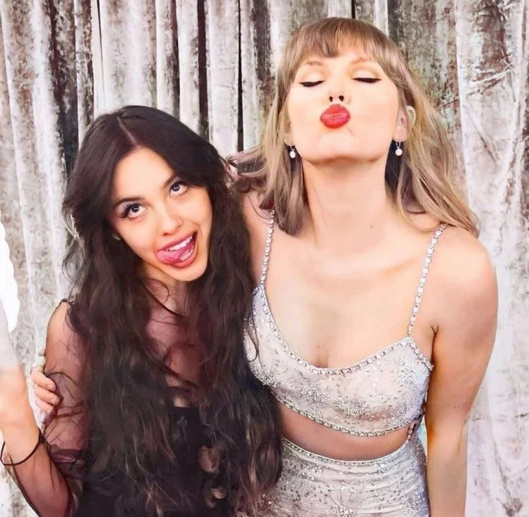 Pop star Taylor Swift poses alongside another singer making silly faces together