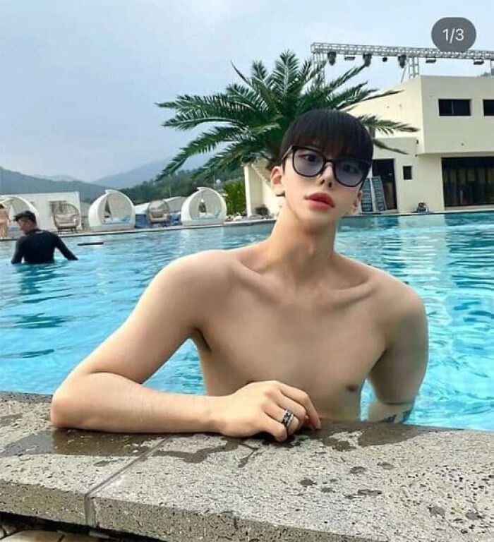 Ridiculously edited photo of shirtless man with slim neck and large sunglasses by pool