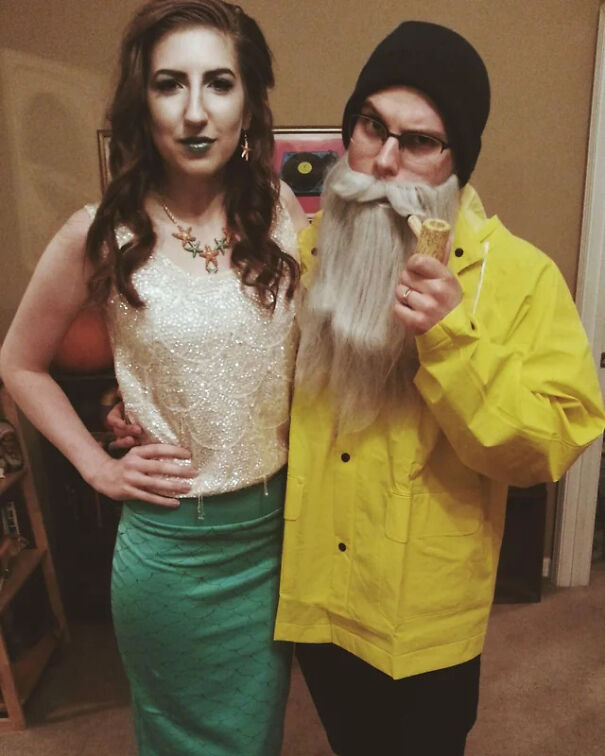 A couple dressed in a fisherman and mermaid Halloween costume.