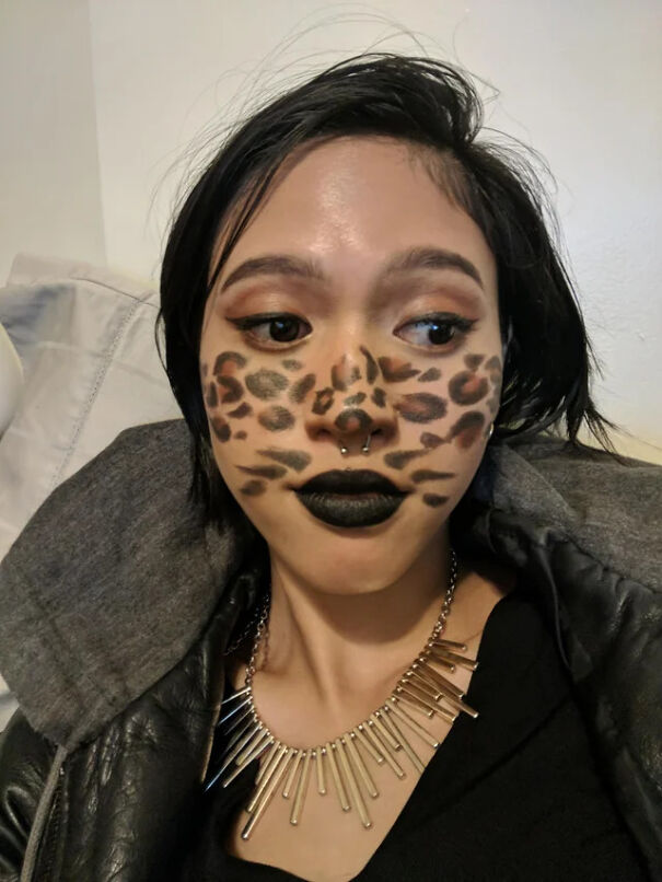 Woman showcasing leopard print face makeup for simple Halloween costume ideas.