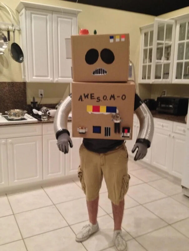 Person wearing a homemade AWESOM-O cardboard robot suit as a funny Halloween costume idea.