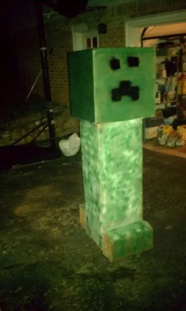 A home-made Minecraft Creeper figure standing outdoors as a fun DIY Halloween costume idea.