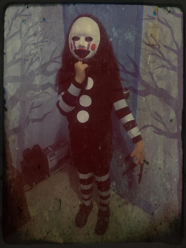 Spooky child wearing a Puppet mask, showing off a last-minute homemade Halloween costume idea.