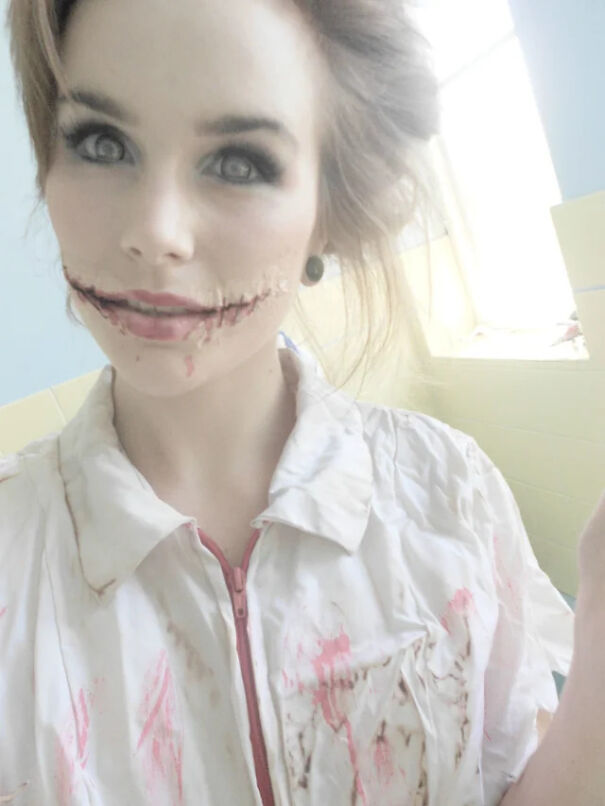 Woman wearing bloody nurse outfit with stitched mouth makeup for a Halloween costume idea