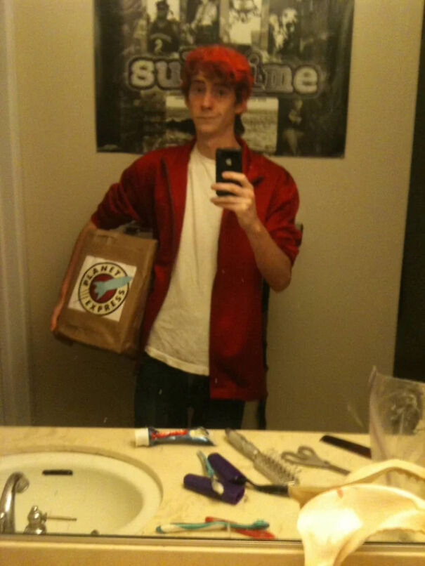 Man taking a mirror selfie dressed as Fry from Futurama for a simple Halloween costume idea