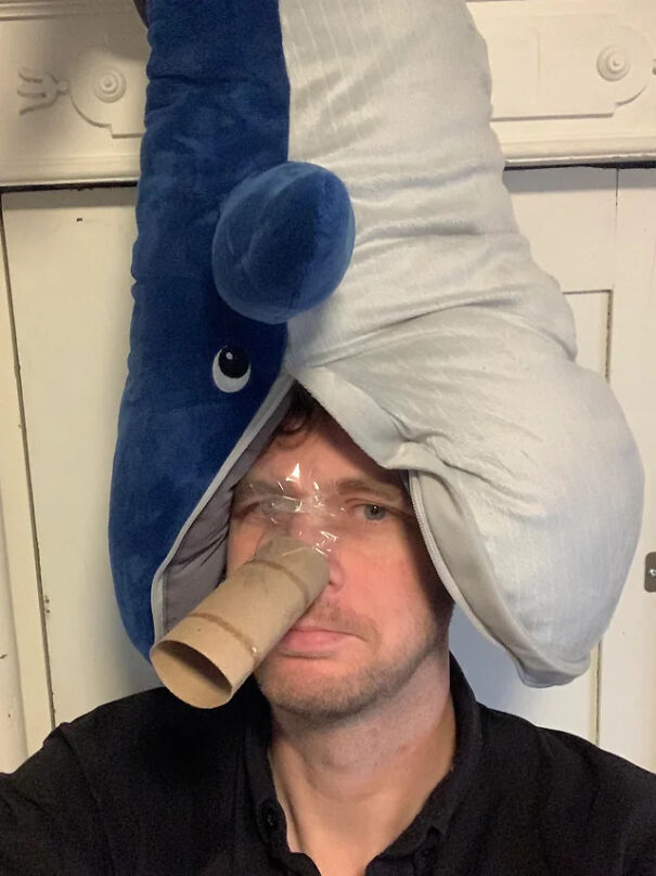 Man wearing a plush shark on his head as a funny Halloween costume idea