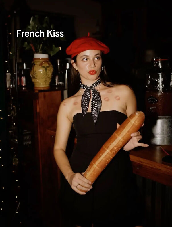 Woman dressed as French Kiss for a clever Halloween costume idea holding a baguette