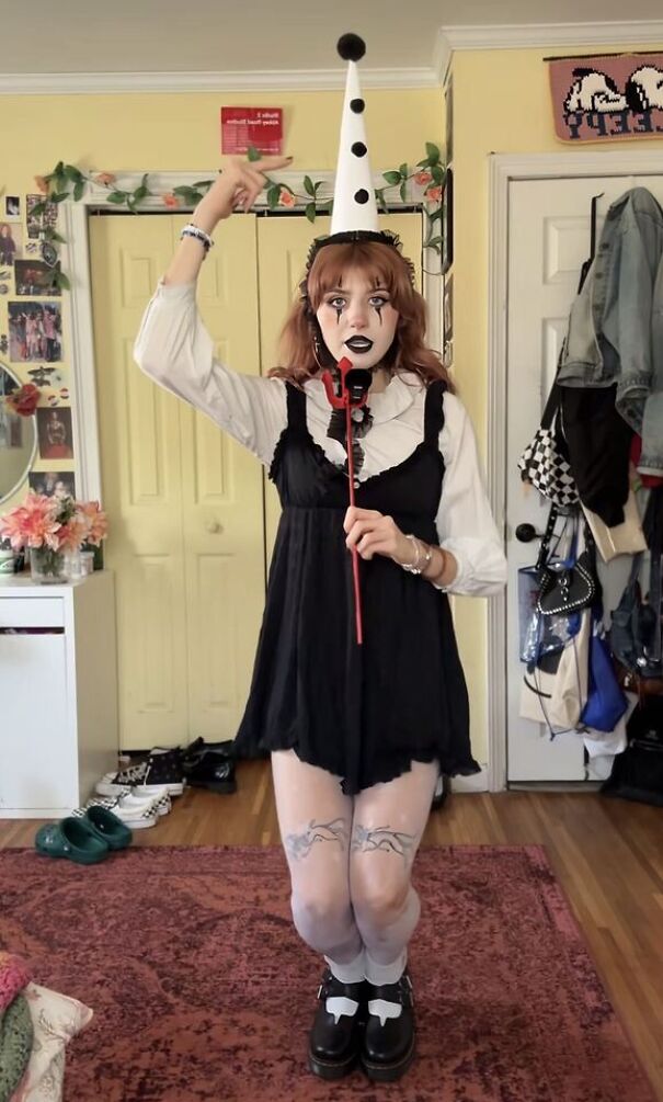 Woman in pierrot clown makeup and black dress, a unique Halloween costume idea
