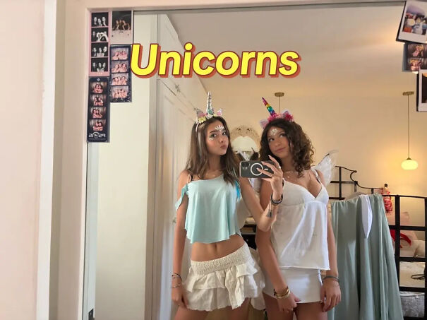Two girls wearing matching outfits and horns as a DIY unicorns Halloween costume idea.