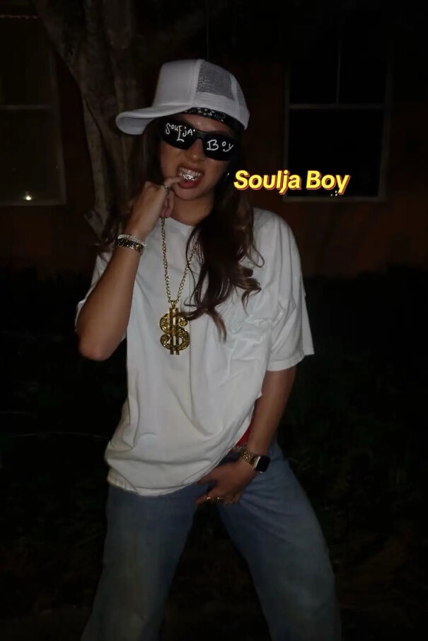 A person dressed in a white cap, sunglasses, and gold chain as a Soulja Boy Halloween costume idea.