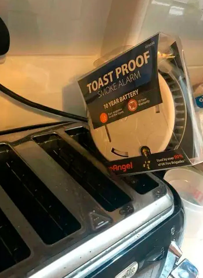 A smoke alarm package labeled toast proof sitting on top of a toaster illustrating confusing labels.