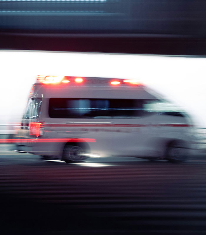 Blurry photo of a speeding ambulance with lights flashing. Blurry photo of a speeding ambulance with lights flashing.