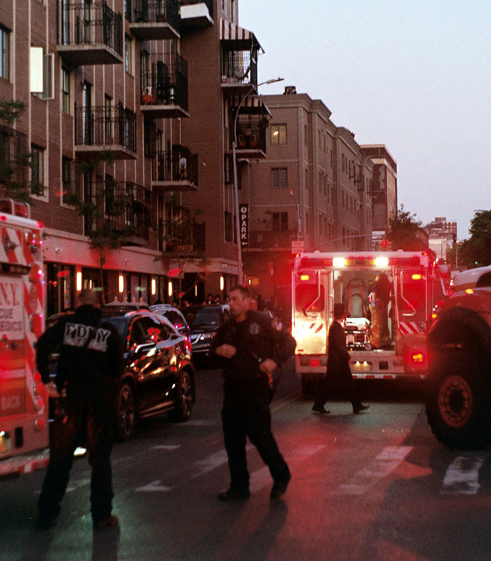 Emergency personnel and an ambulance on a busy city street. Emergency personnel and an ambulance on a busy city street.