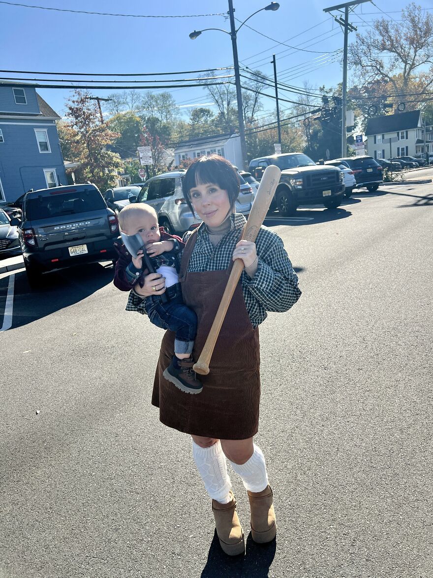 Woman holding a baby in matching Wendy and Danny Torrance creative Halloween costume ideas
