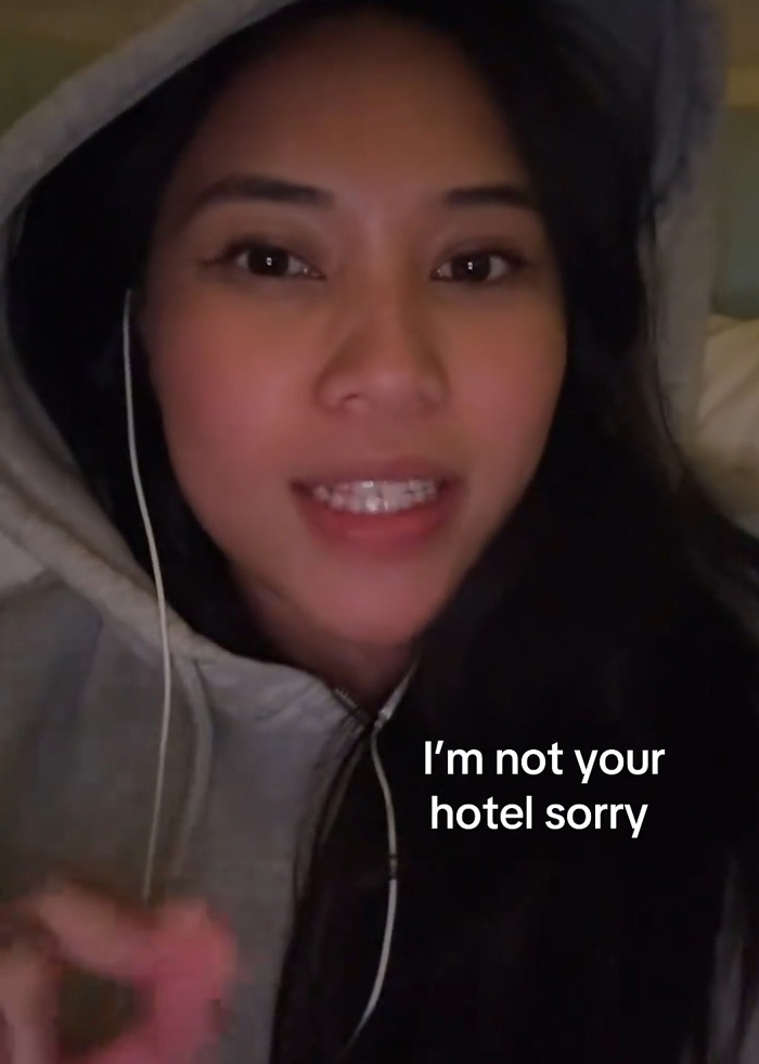 Woman in hoodie talking about why friends are not entitled to her couch instead of NYC hotels Woman in hoodie talking about why friends are not entitled to her couch instead of NYC hotels