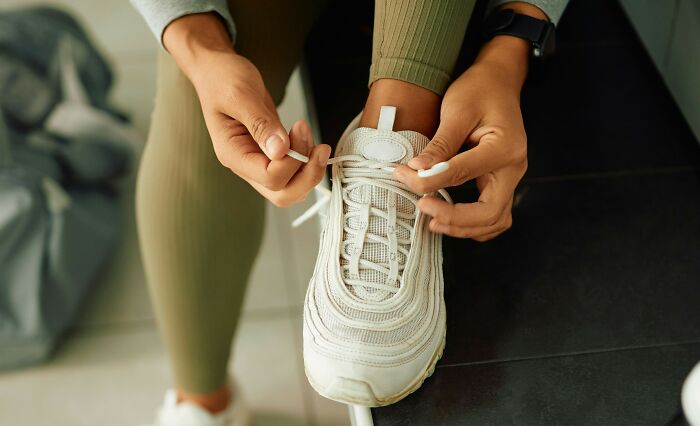 Person tying running shoes, carrying personal secrets folks take to the grave.