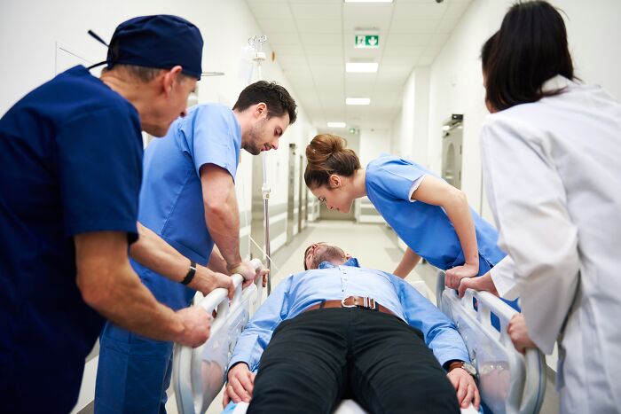Medical team rushing a patient on a gurney, representing industry insiders in healthcare.