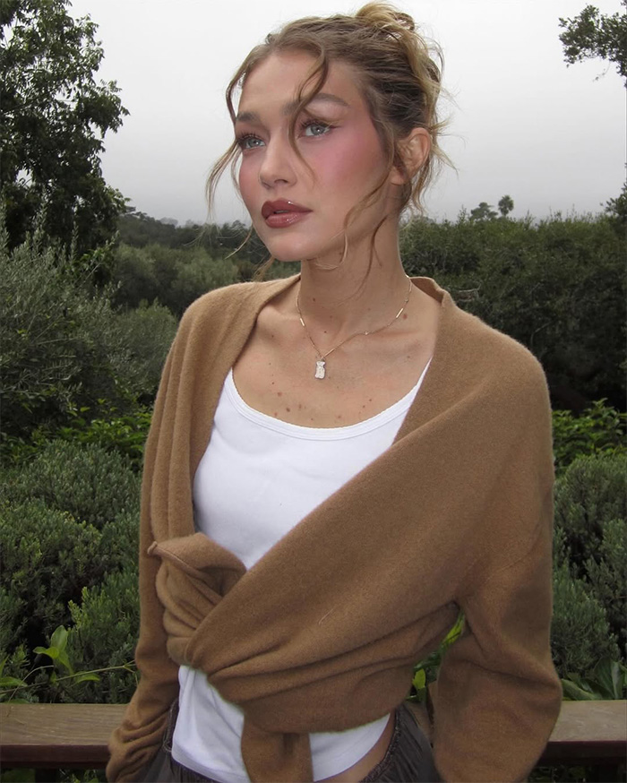 Close up of Gigi Hadid wearing a brown knit wrap sweater Close up of Gigi Hadid wearing a brown knit wrap sweater