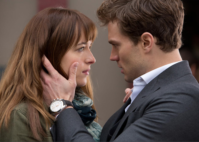 Dakota Johnson and Jamie Dornan gaze into each other's eyes in a movie scene. Dakota Johnson and Jamie Dornan gaze into each other's eyes in a movie scene.