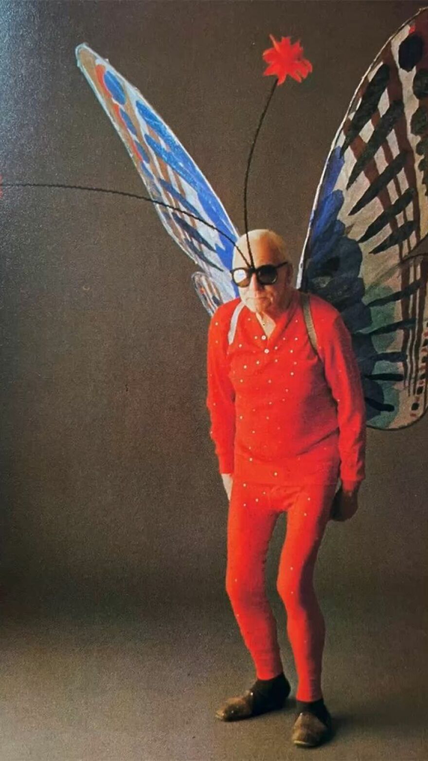 Older man wearing a red suit with giant butterfly wings as a creative Halloween costume idea