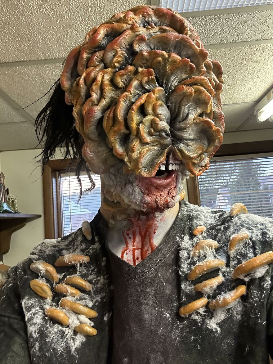 A person wearing a realistic Clicker mask from The Last of Us for creative Halloween costume ideas.